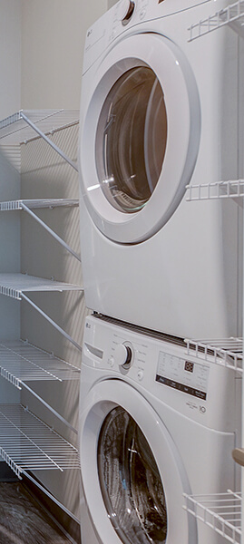 a young woman in shades holding her phone and coffee smiling