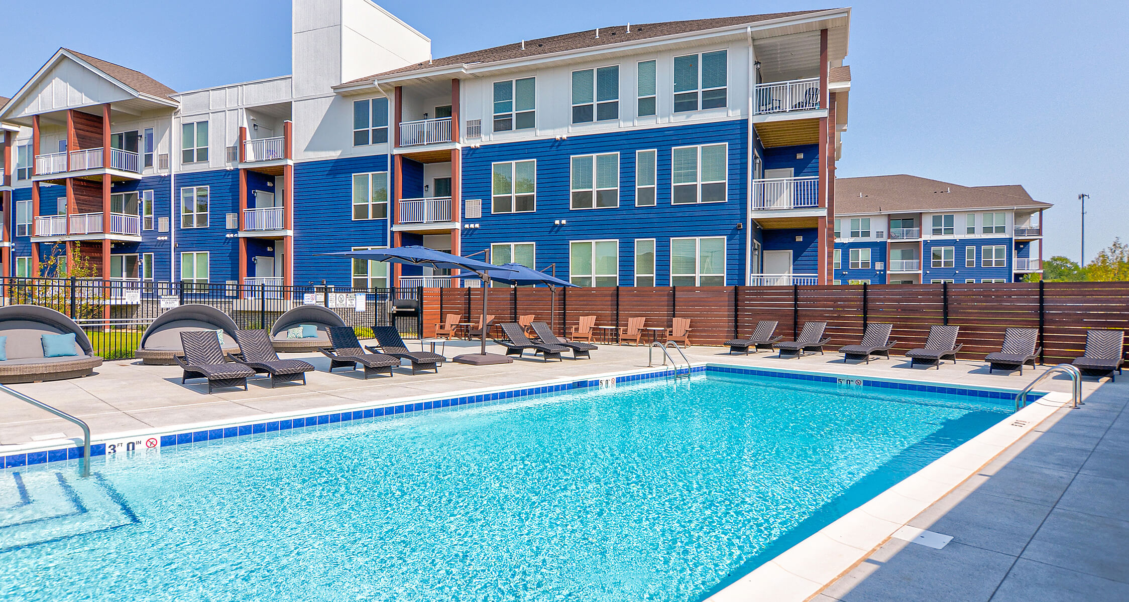 a food tray with a candle, a muffin and coffee on a dark couch
